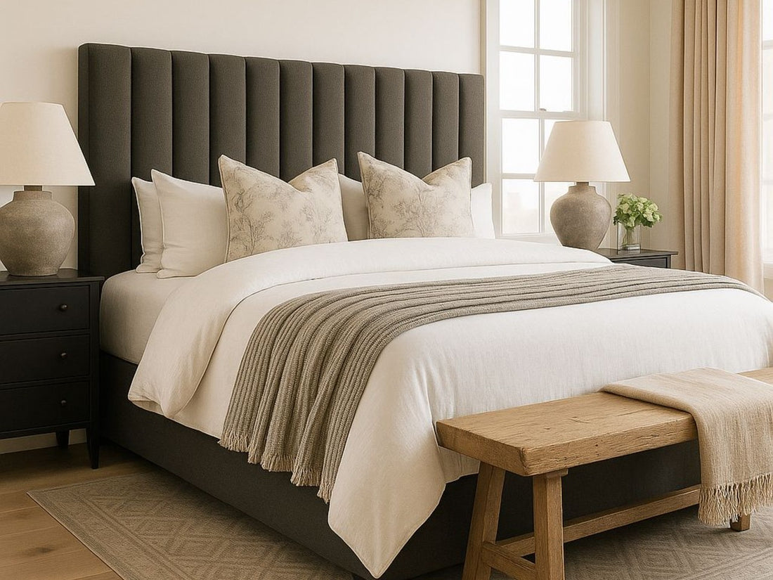 Black Brit bed in Calgary from Showhome Furniture with white pillows and a gray blanket in a bedroom setting.