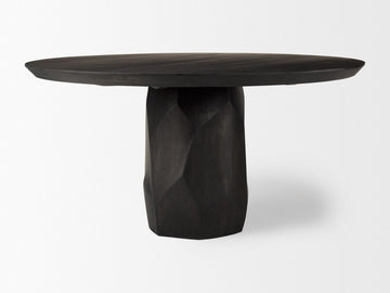 Dark wooden table with a unique base design on a white background