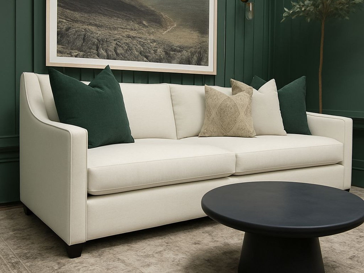 Lease sofa in Calgary with green and beige cushions in a room with a dark green wall and a framed picture.