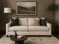 Lease sofa in Calgary with green pillows in a living room setting with a landscape painting on the wall.