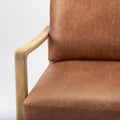 Close-up of Raeleigh Tan Faux Leather Accent Chair in Calgary with wooden frame
