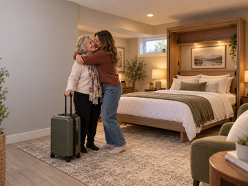 A Calgary family welcomes a grandmother beside an opened cabinet Murphy bed in a cozy basement guest room.