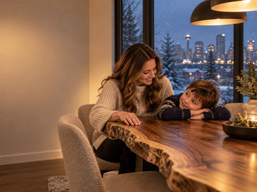 A Calgary mother and young son share a quiet snowy evening beside a warm live edge dining table.