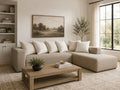 Beige fabric sectional with chaise and accent pillows in a cozy modern living room.