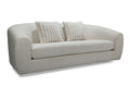 Curved light fabric sofa with two accent pillows on a white background.