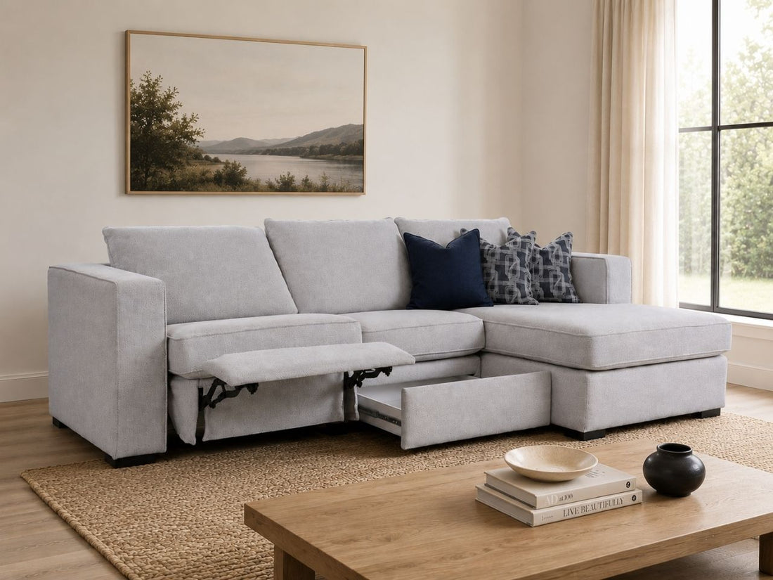 Light gray sectional with power recliner and storage drawer in a cozy modern living room.