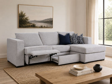 Light gray sectional with power recliner and storage drawer in a cozy modern living room.