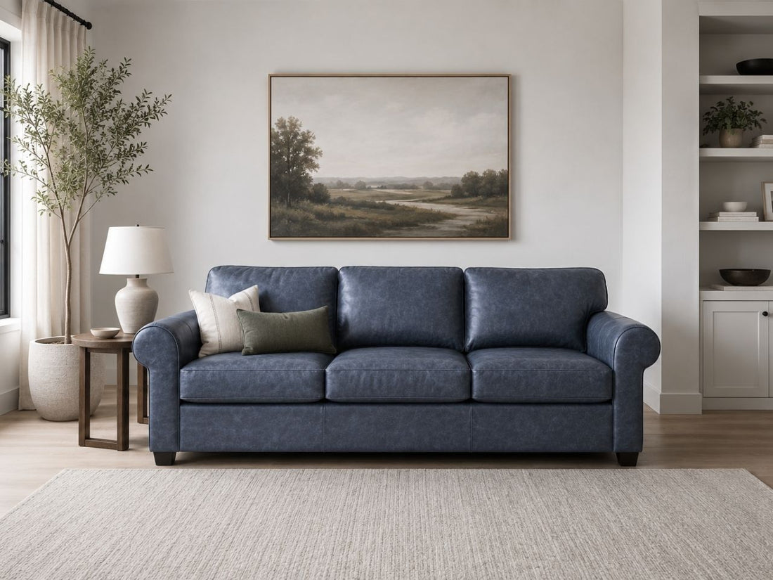 Blue leather sofa with accent pillows in a bright, modern living room.