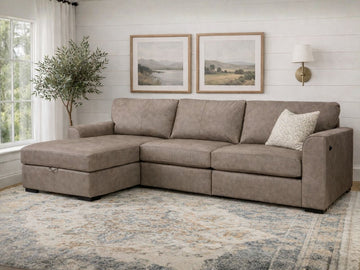 A taupe upholstered sectional sofa with a chaise in a bright, neutral living room.