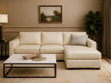A Custom leather sectional sofa with a right-facing chaise lounge in a warm, neutral living room.