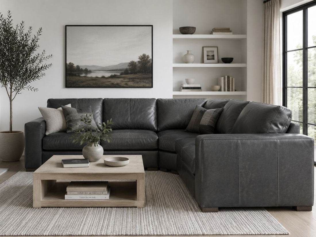 Gray leather sectional with deep seating and contemporary design.