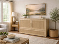 Light wood sideboard with paneled doors and brass hardware, styled in a bright, neutral living room.