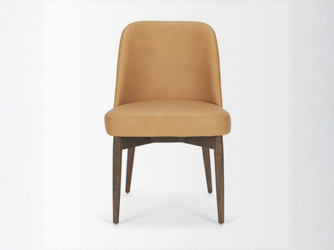 Tan upholstered dining chair with wooden legs on a white background.