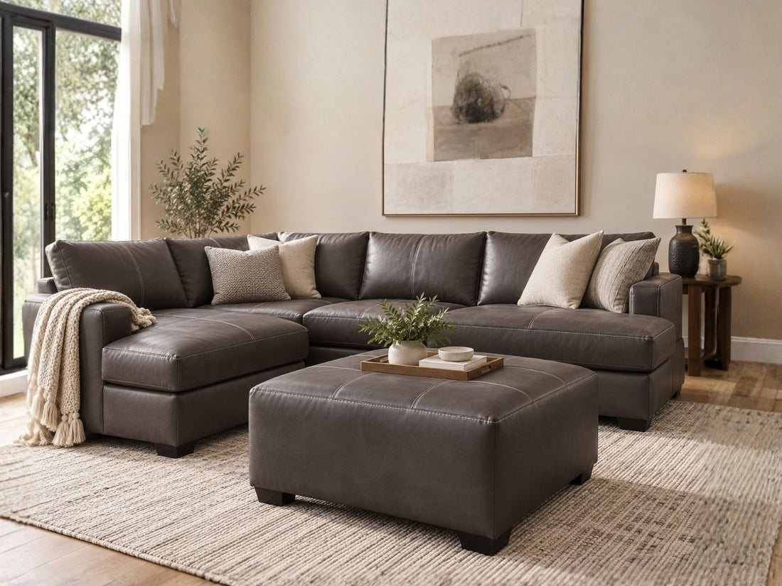 Dark brown leather ottoman with matching sectional sofa in a modern living room, featuring stylish living room furniture in Calgary with a warm, contemporary design.
