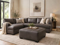 Dark brown leather ottoman with matching sectional sofa in a modern living room, featuring stylish living room furniture in Calgary with a warm, contemporary design.