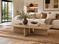 Light oak rectangular coffee table with architectural pedestal legs, styled in a bright and inviting living room.