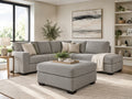 Light grey upholstered ottoman with matching sectional sofa in a bright modern living room, featuring stylish ottoman furniture in Calgary and contemporary home décor.