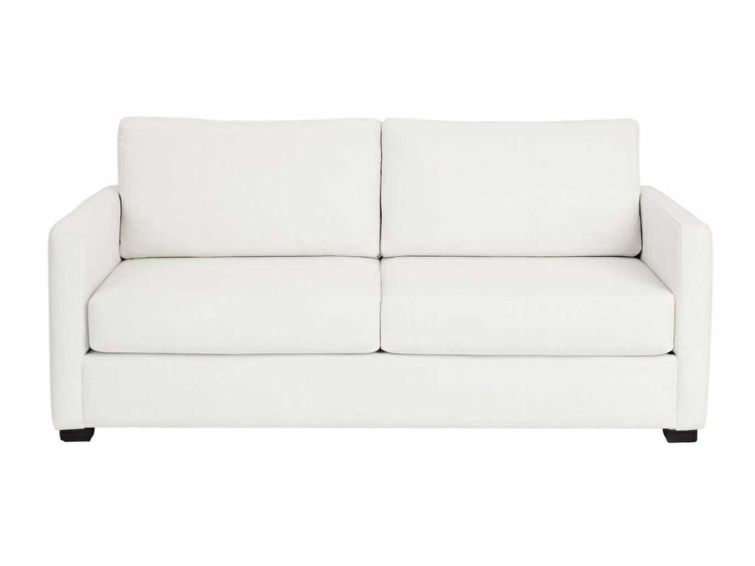 White sofabed in Calgary with dimensions marked on a wooden floor in a room with a painting on the wall.
