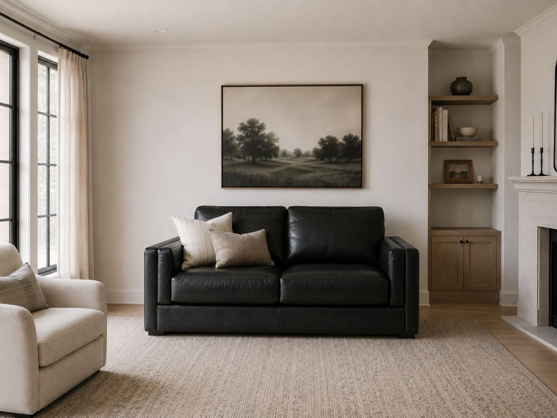 Black leather loveseat with sleek modern styling.