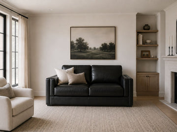 Black leather loveseat with sleek modern styling.