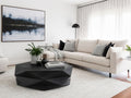 Black geometric coffee table styled in a modern living room with a light sofa and contemporary décor.