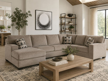 Soft taupe fabric sectional with chaise in a warm modern living room.