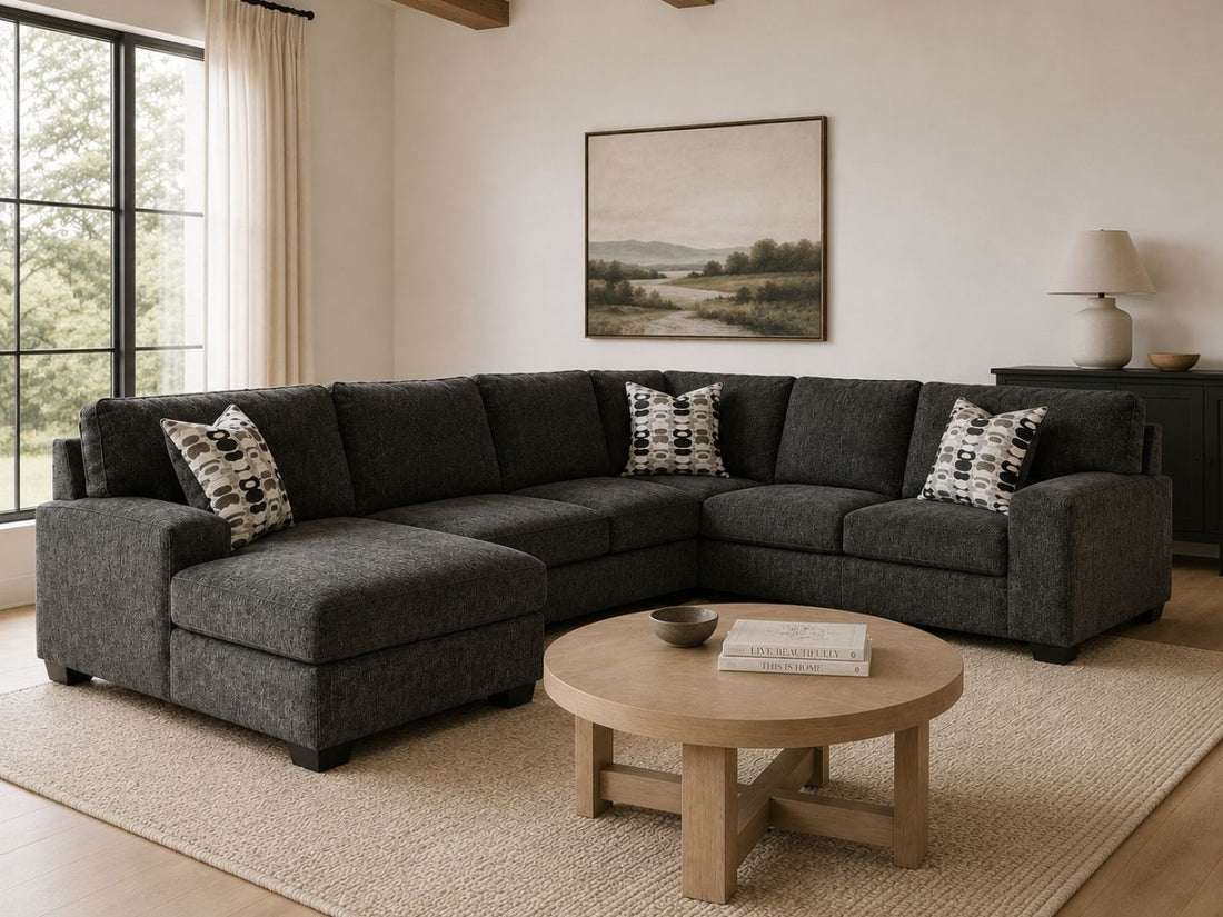 Dark gray sectional sofa with chaise in a cozy modern living room.