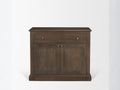 Brown solid wood accent cabinet with drawer and double doors against a white wall.