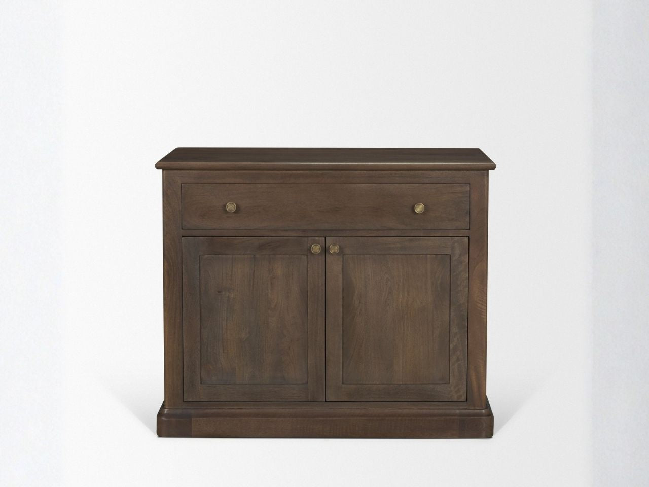 Brown solid wood accent cabinet with drawer and double doors against a white wall.