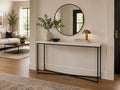 White marble-top console table with a black metal frame styled in a modern entryway.