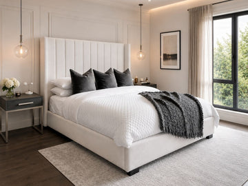 Modern upholstered bed with a tall channel-tufted headboard in a bright contemporary bedroom.