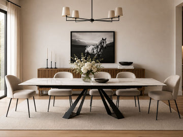 White dining table with six upholstered chairs and a black metal base.