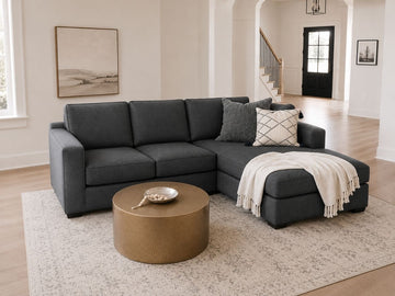 Dark gray sectional with chaise in a modern living room.