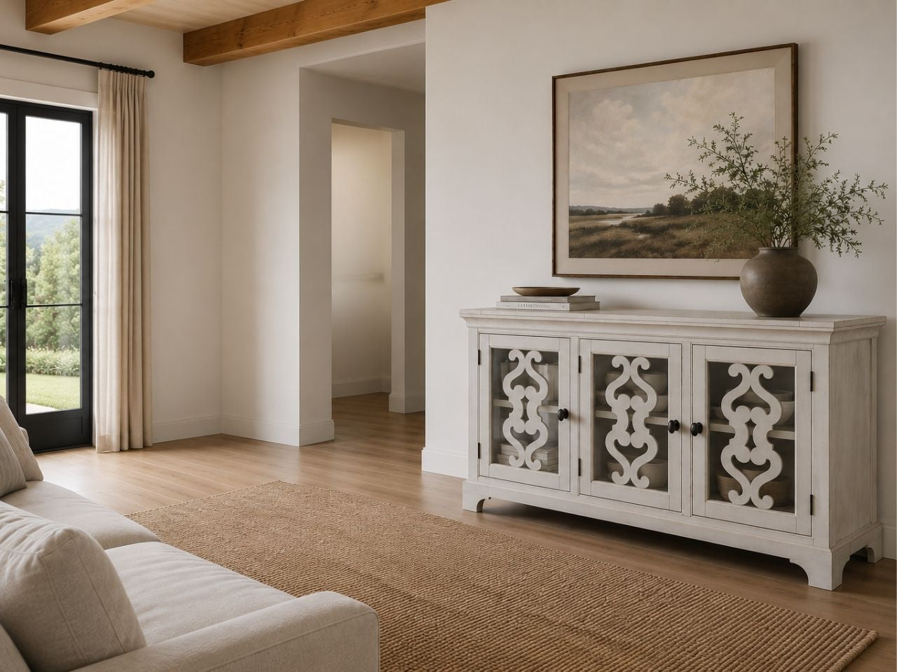 Refined whitewashed server featuring decorative fretwork glass doors and classic transitional styling.