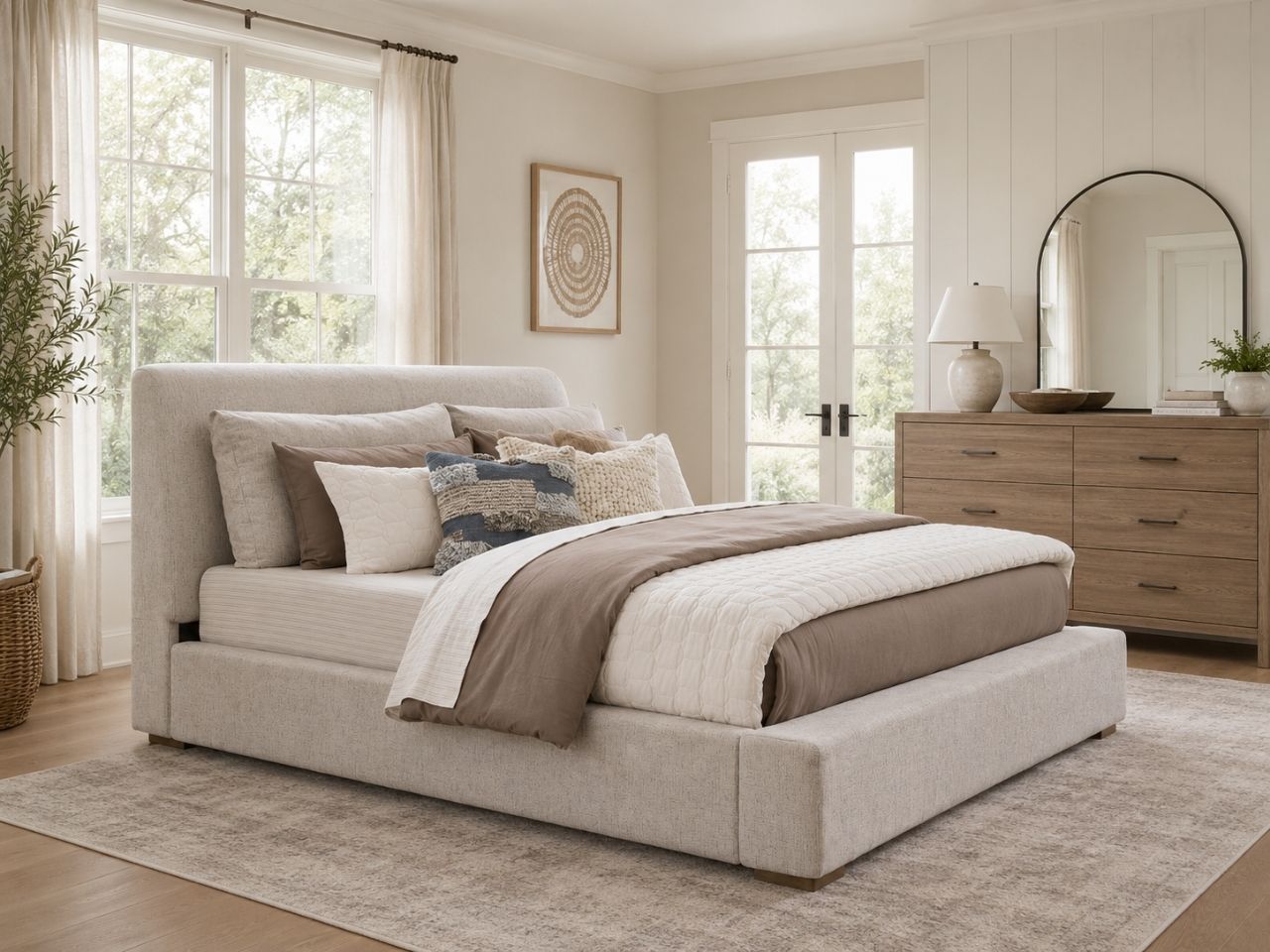 Soft neutral upholstered bed with a clean modern design in a cozy bedroom setting.
