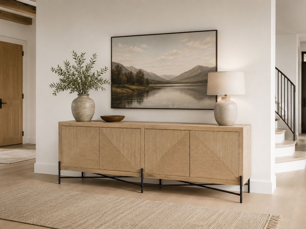 Light wood sideboard with textured geometric doors and metal legs.