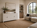 Elegant white sideboard showcasing intricate hand-carved lace-inspired detailing and timeless charm.