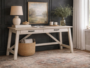 The Carynhurst Home Office Desk features a rustic farmhouse aesthetic, crafted from wood with a light, whitewashed finish that emphasizes the natural wood grain.