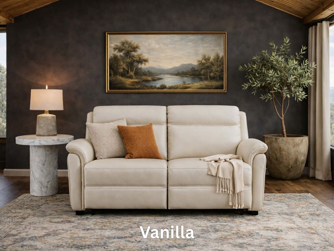 A bright cream leather sofa centered under a gold-framed landscape painting with a marble coffee table.