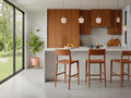 Wood counter stools at a kitchen island in a modern kitchen.
