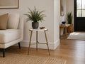 Round marble-top accent table with a gold metal frame styled beside a neutral sofa in a bright modern living room.