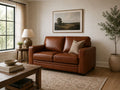 Brown leather loveseat in a warm modern living room with cozy neutral decor.
