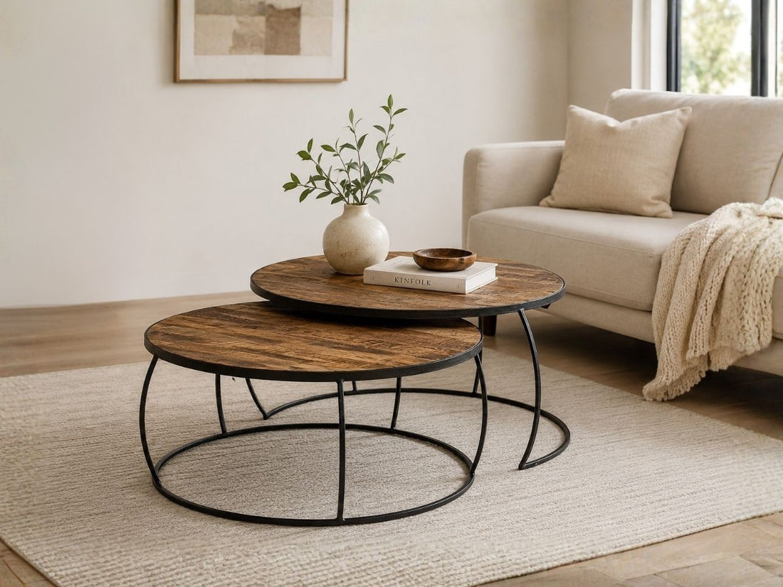 Round nesting coffee table set with rustic wood tops and black metal frames in a modern living room.