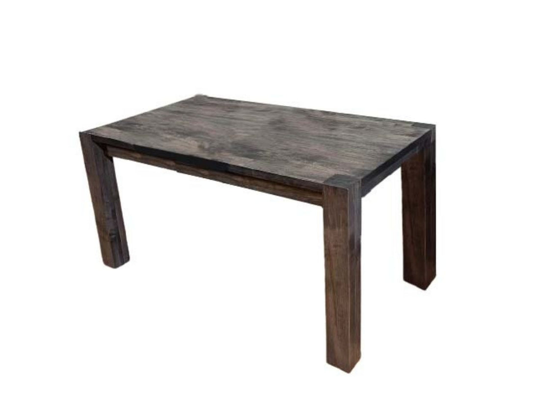 Solid wood dining table with six chairs in a bright dining room.