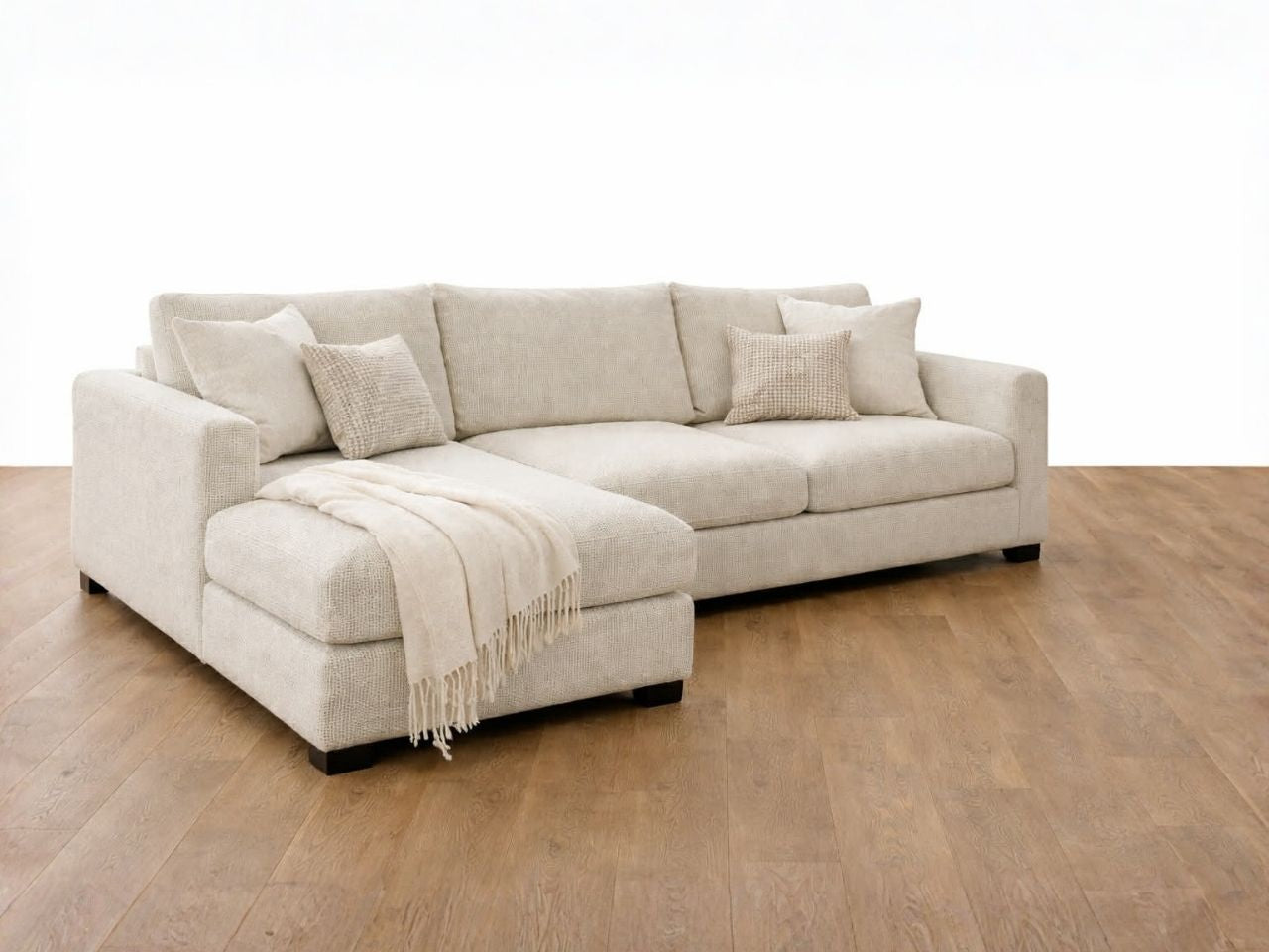 Clean-lined sectional featuring plush cushions and a chaise, crafted in durable fabric. 
