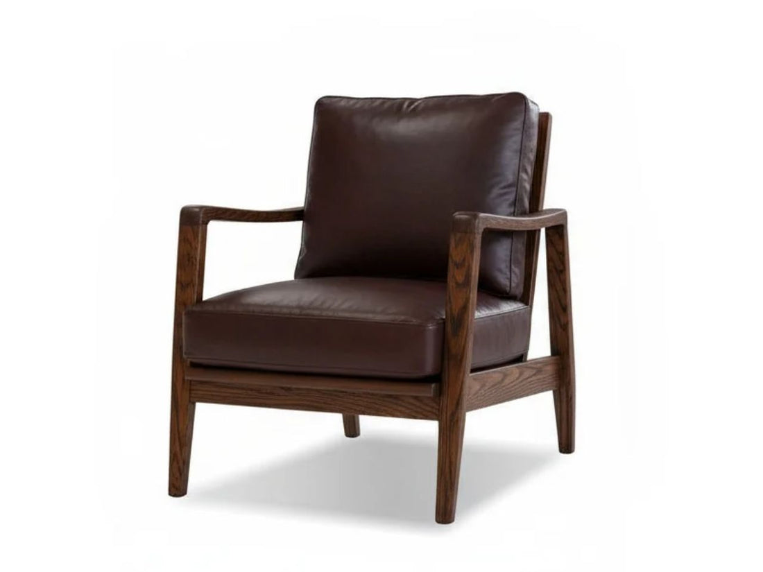 Brown leather accent chair with a wooden frame in a modern neutral living room.