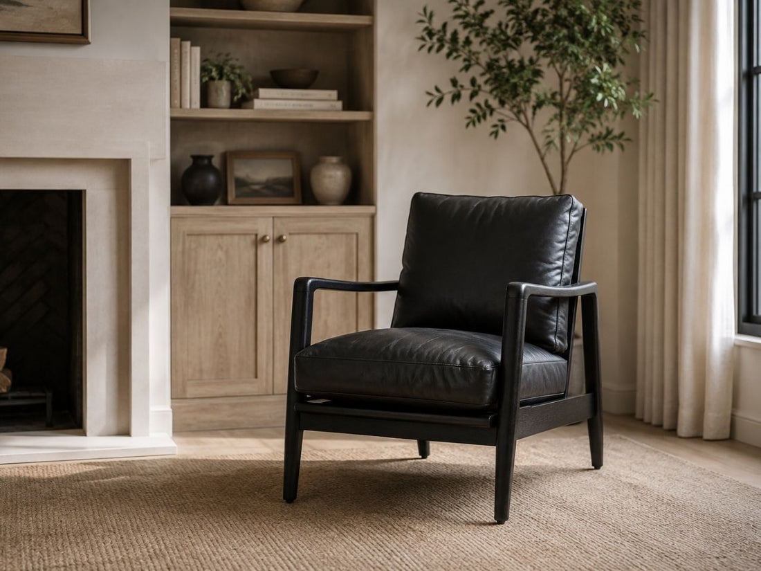 Black leather accent chair in a modern neutral living room.