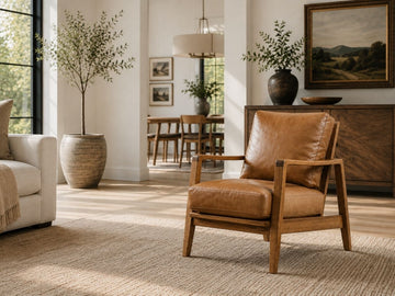 Tan leather accent chair with a wooden frame in a modern Calgary living room.