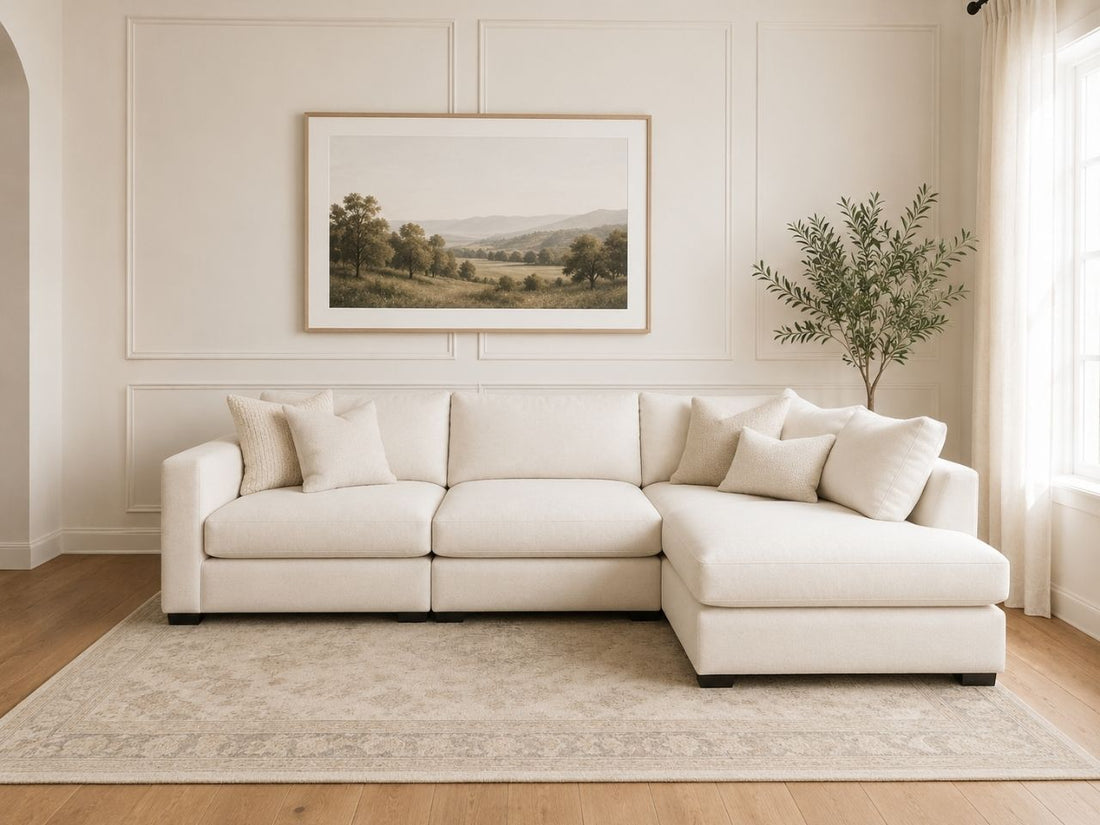 Cream sectional sofa with chaise in a bright, modern living room.