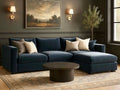 A plush navy blue velvet sectional with a right-facing chaise lounge in a room with wall sconces and olive tree.